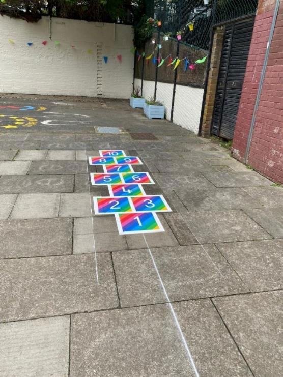 An attractive play area with colourful graphics on the paving