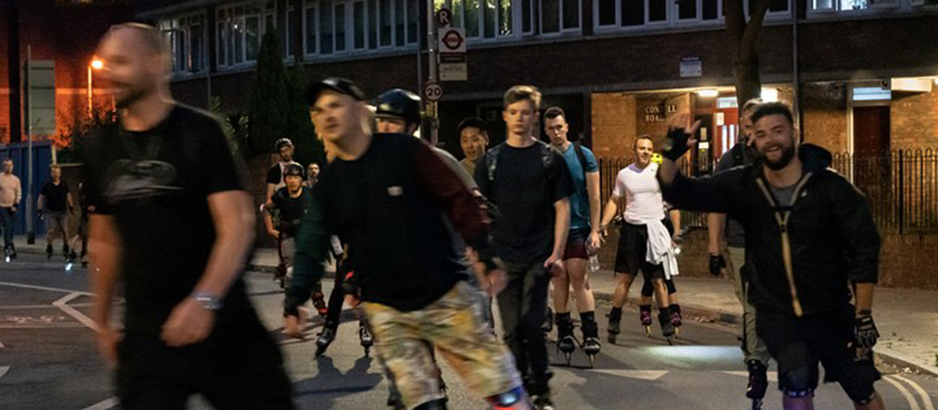 A night shot showing people skating along a street on roller blades, having fun