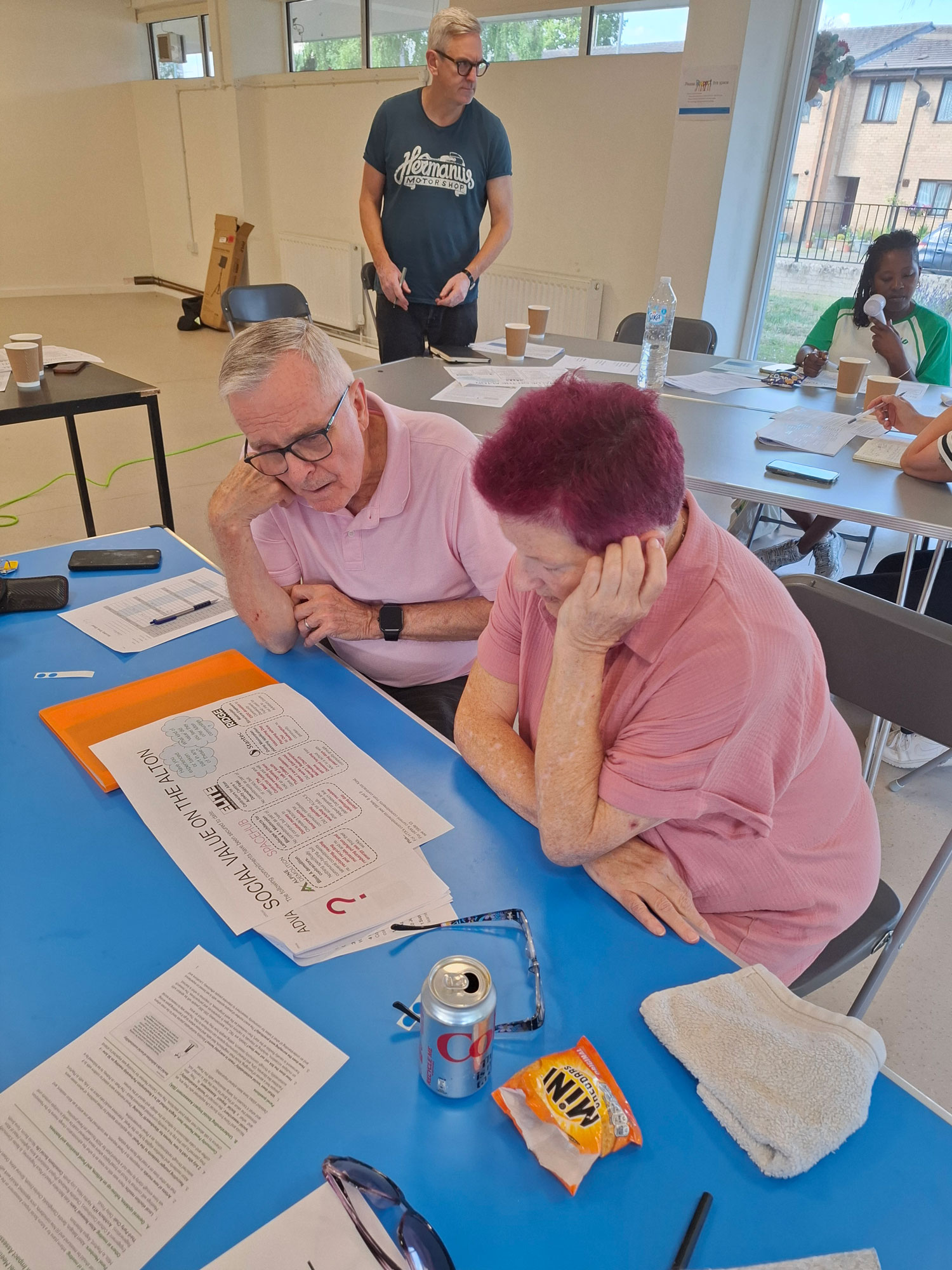 Two people are pictured sitting at a table, studying a chart titled 