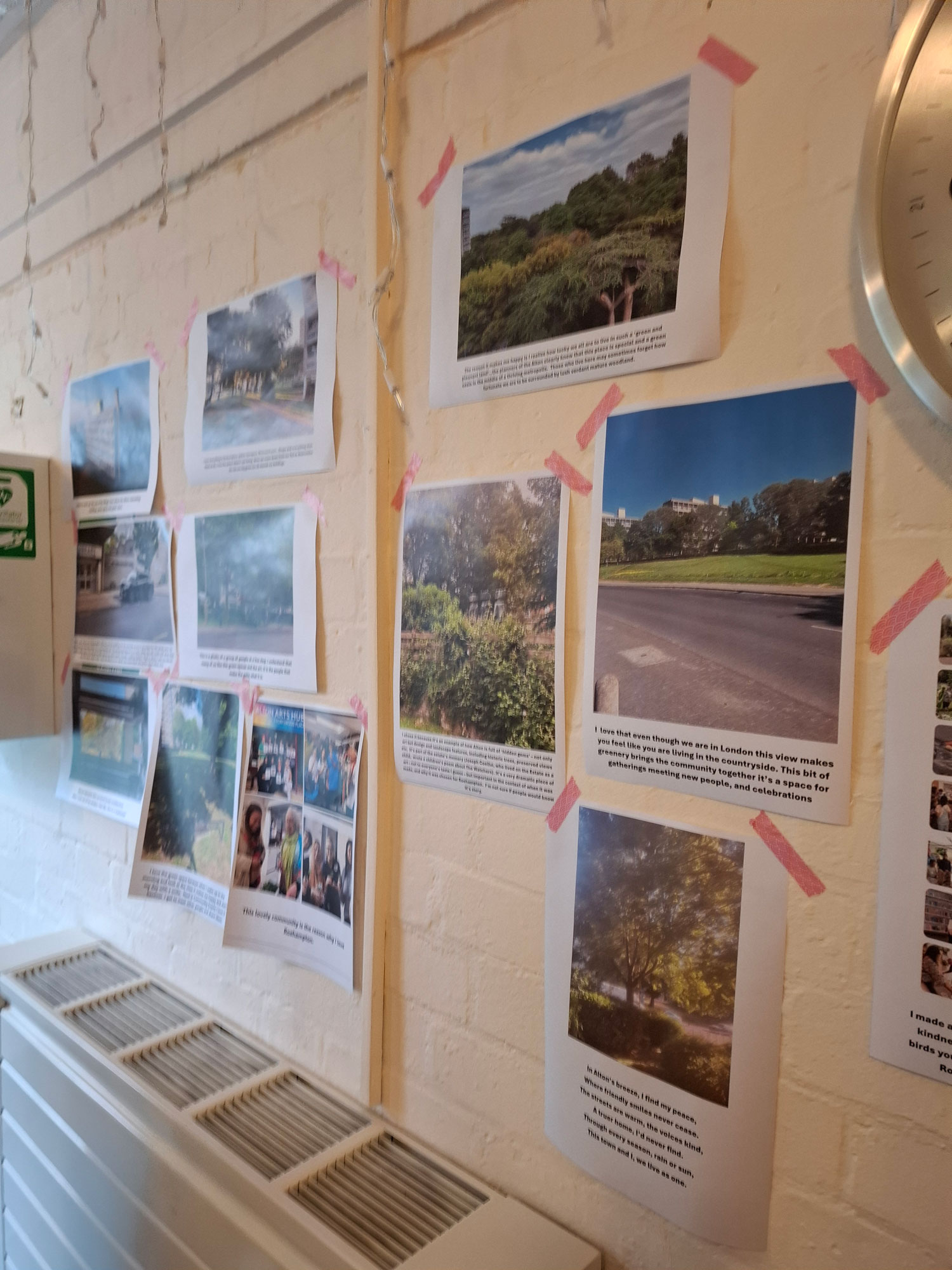 Pictures are displayed on a wall with writing underneath them.